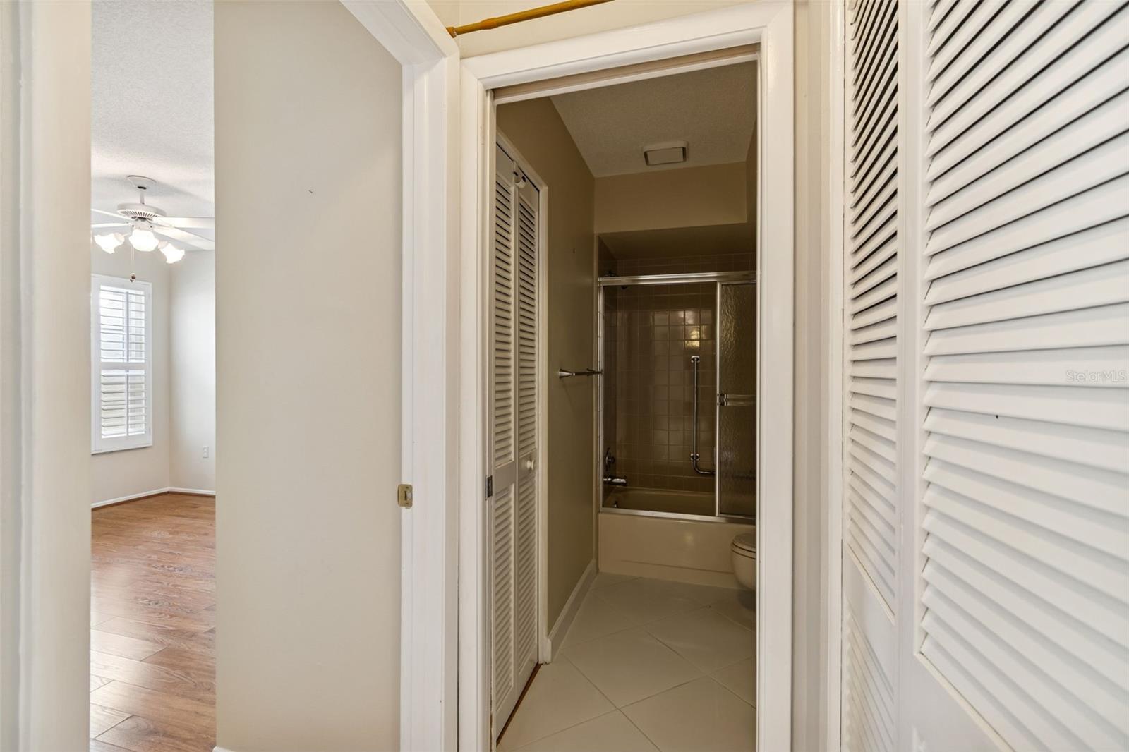 Hall bath conveniently located next to second bedroom.