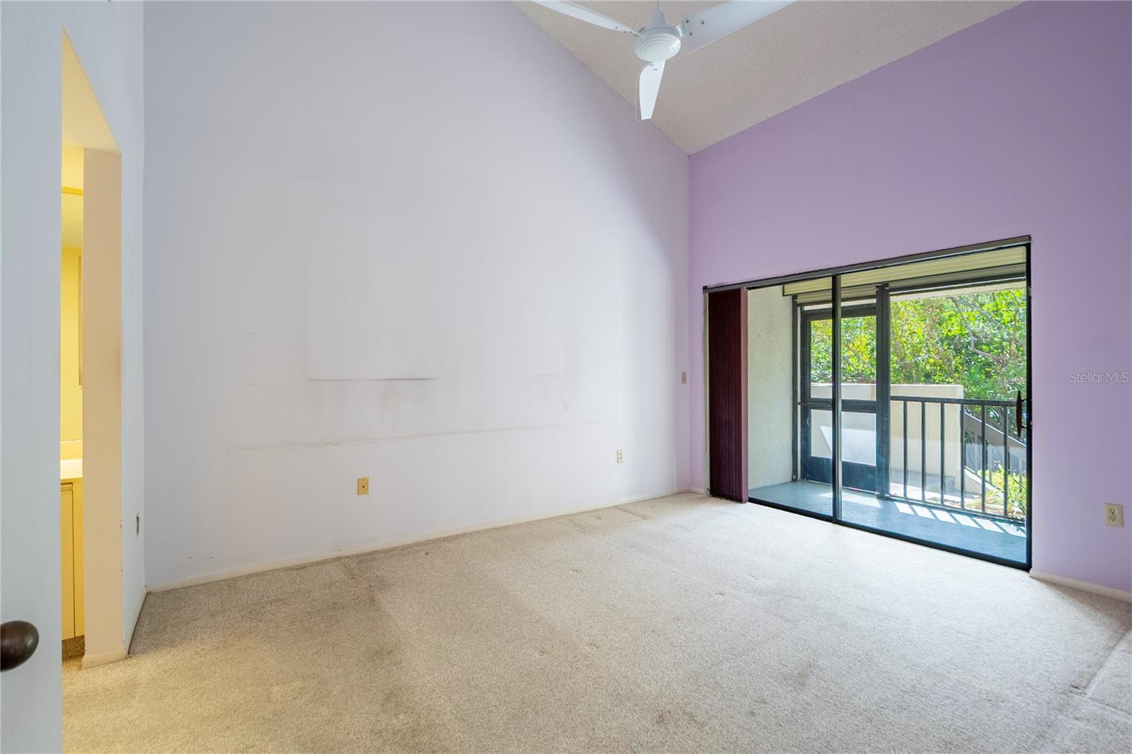 Primary bedroom is easily accessible to screened lanai