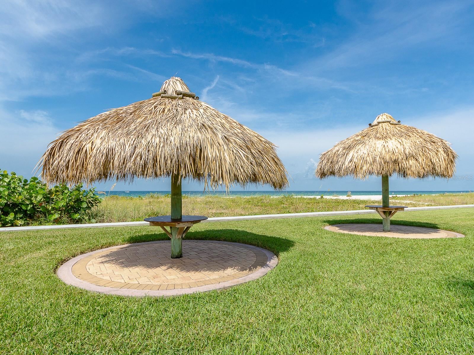 Relax at the tiki tables by the beach!