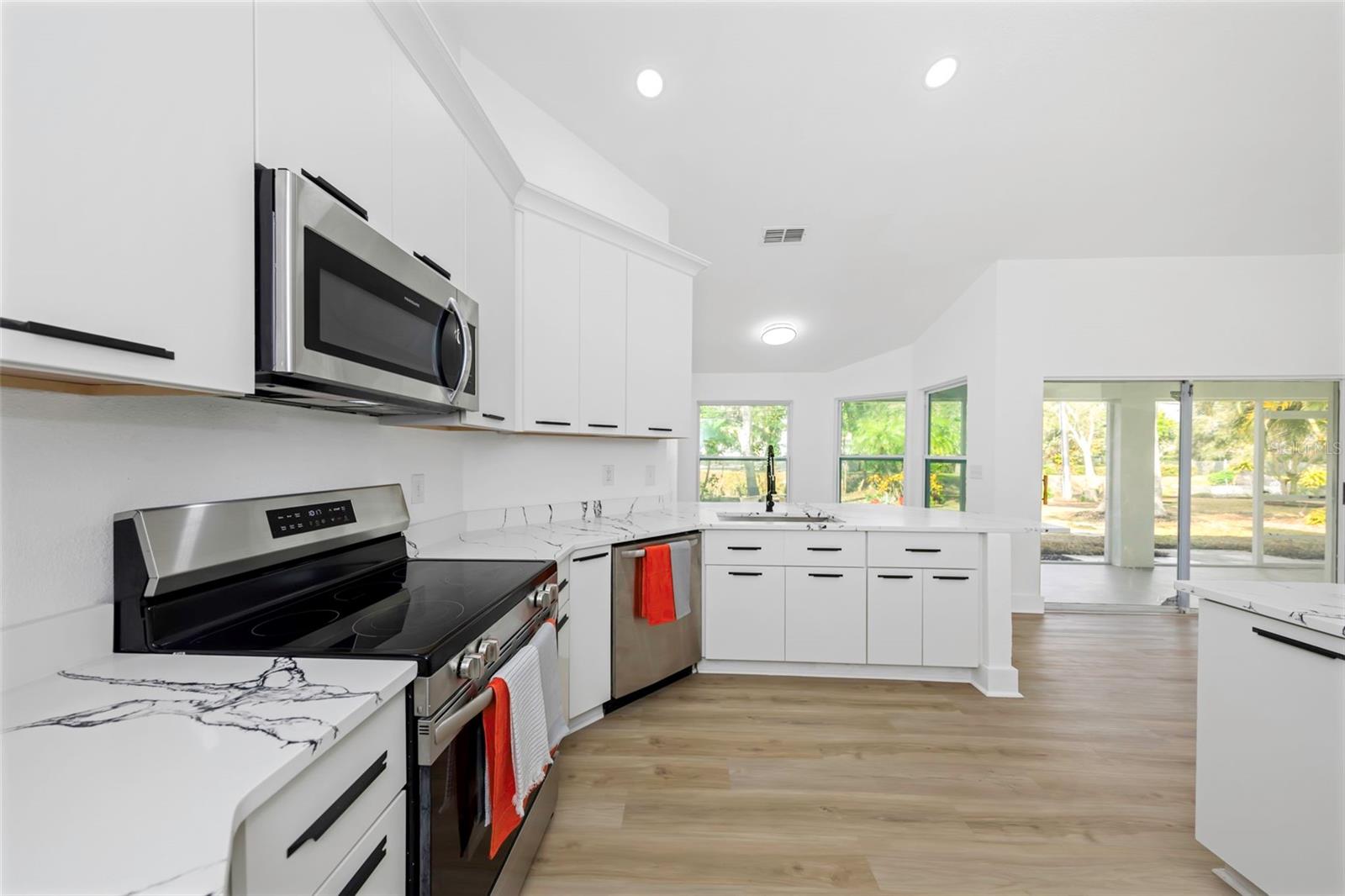 Elegant kitchen with views of the tropical backyard