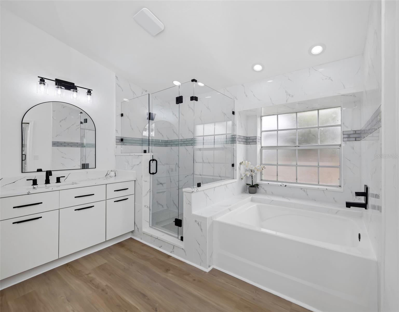 Spa like Master Bath, soaking tub , glass enclosed shower and one of the his/hers vanities