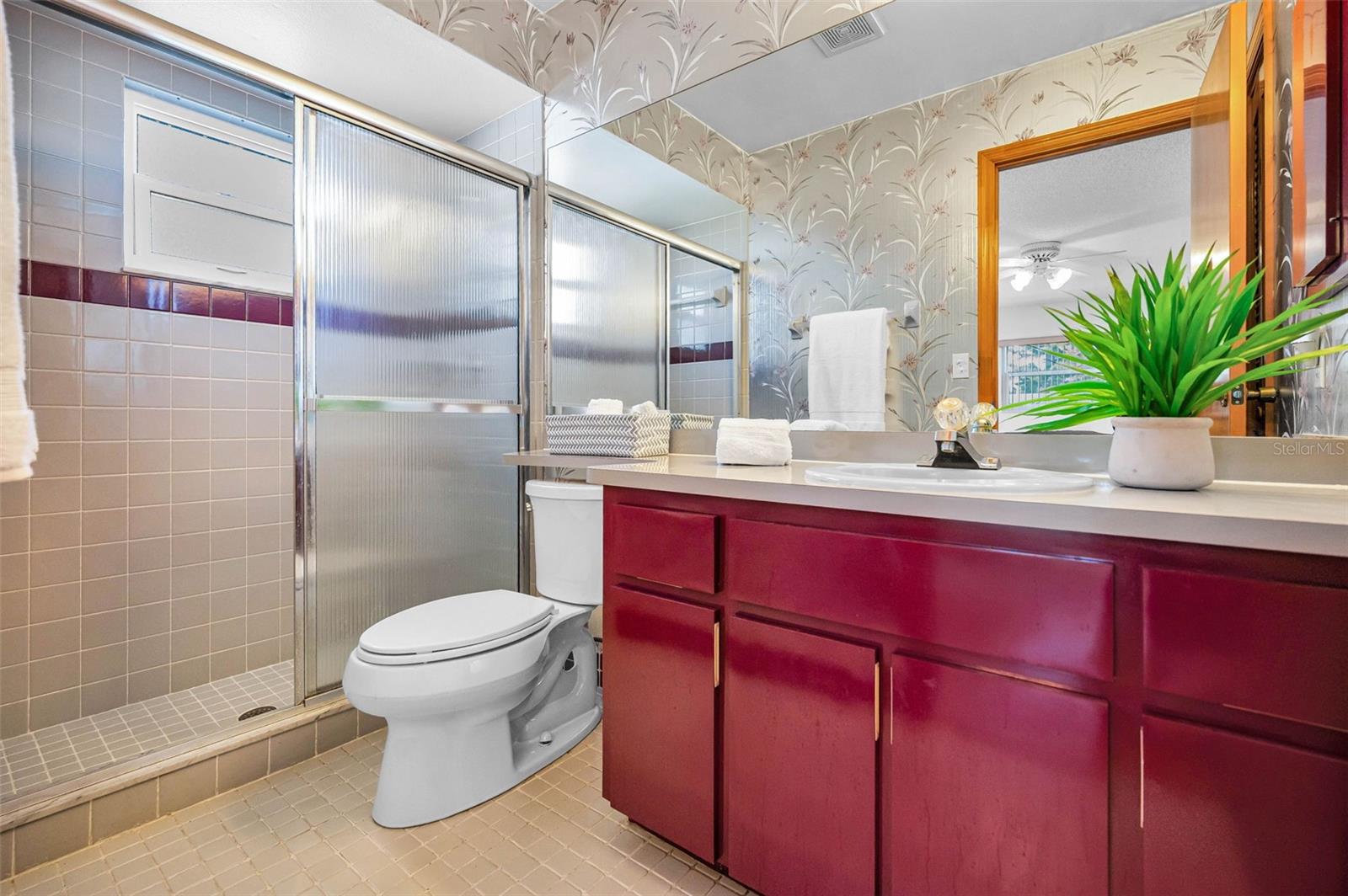 This primary bathroom is a bright and fun, modern space, perfect for relaxation and rejuvenation after a long day. The combination of natural light and stylish fixtures creates a welcoming atmosphere.