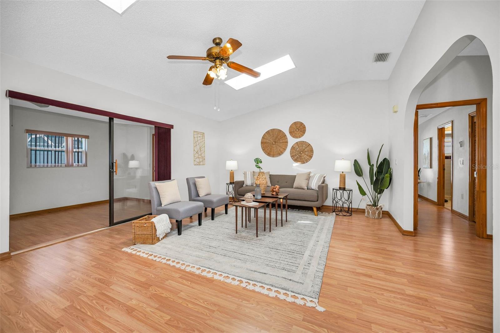 View from corner of Living Room toward Florida Room to the left and Primary Suite to the Right.