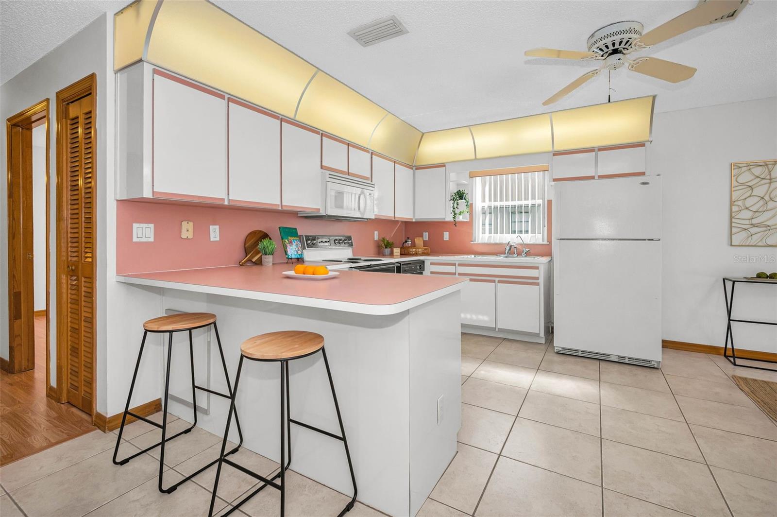 A very spacious kitchen with an attached dining room to the right. There is lots of space, which creates a great flow for families and entertaining.