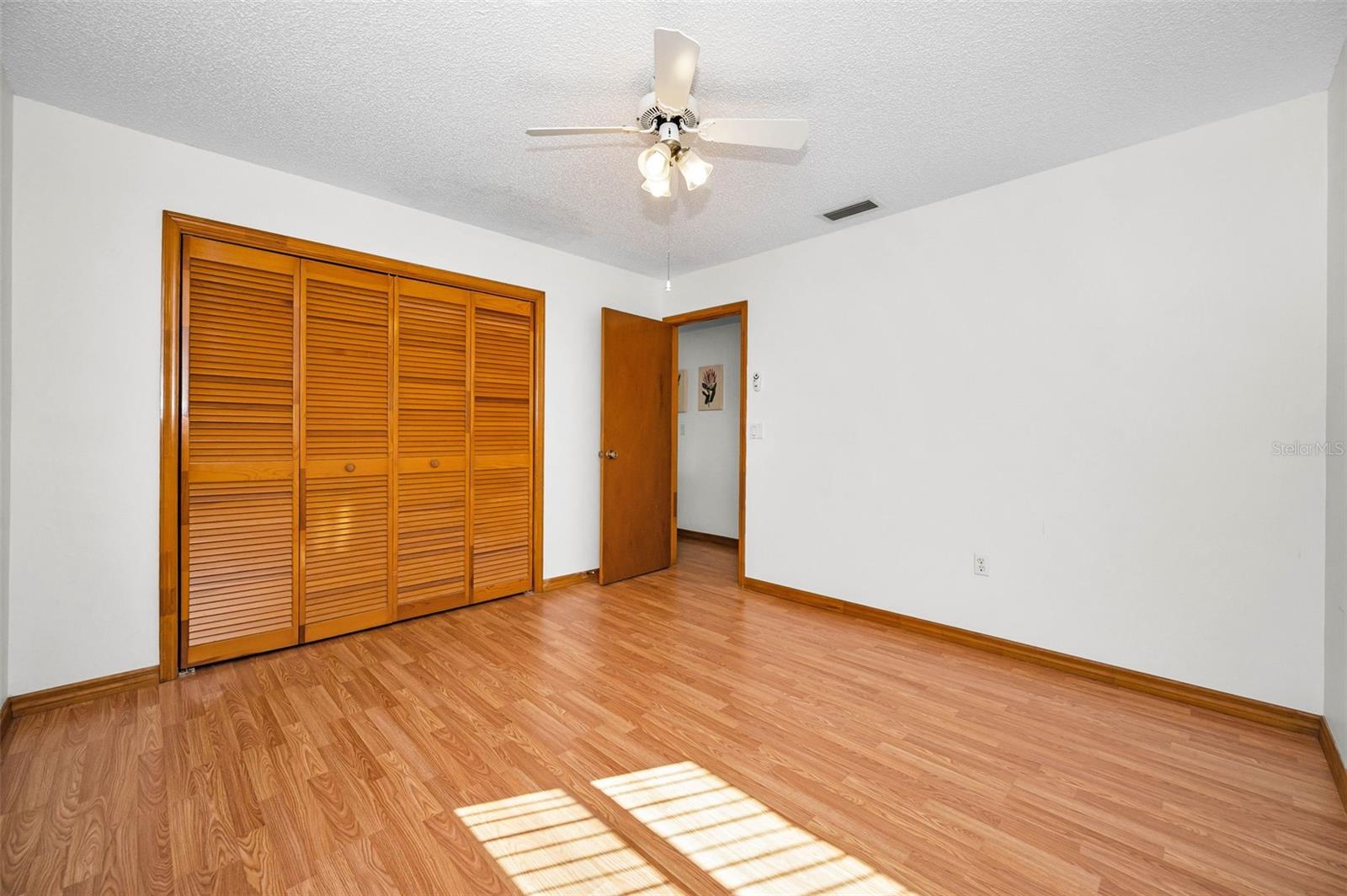 Second Bedroom, across the house from the Primary Bedroom and large enough to give you lots of options. This spacious room offers versatility for various uses, such as a guest room, home office, or even a creative studio. Its location provides privacy and tranquility, making it an ideal retreat within the home.