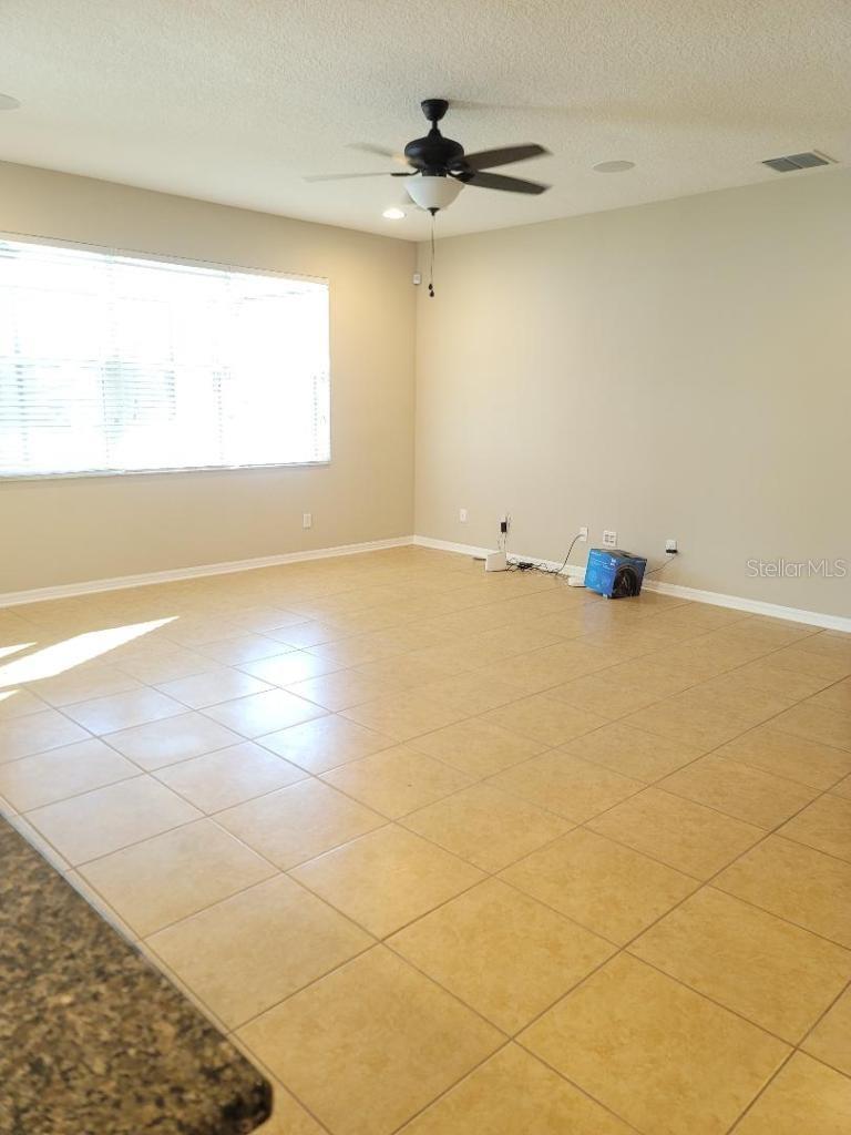 Family/ living room with blinds wide open lots of light