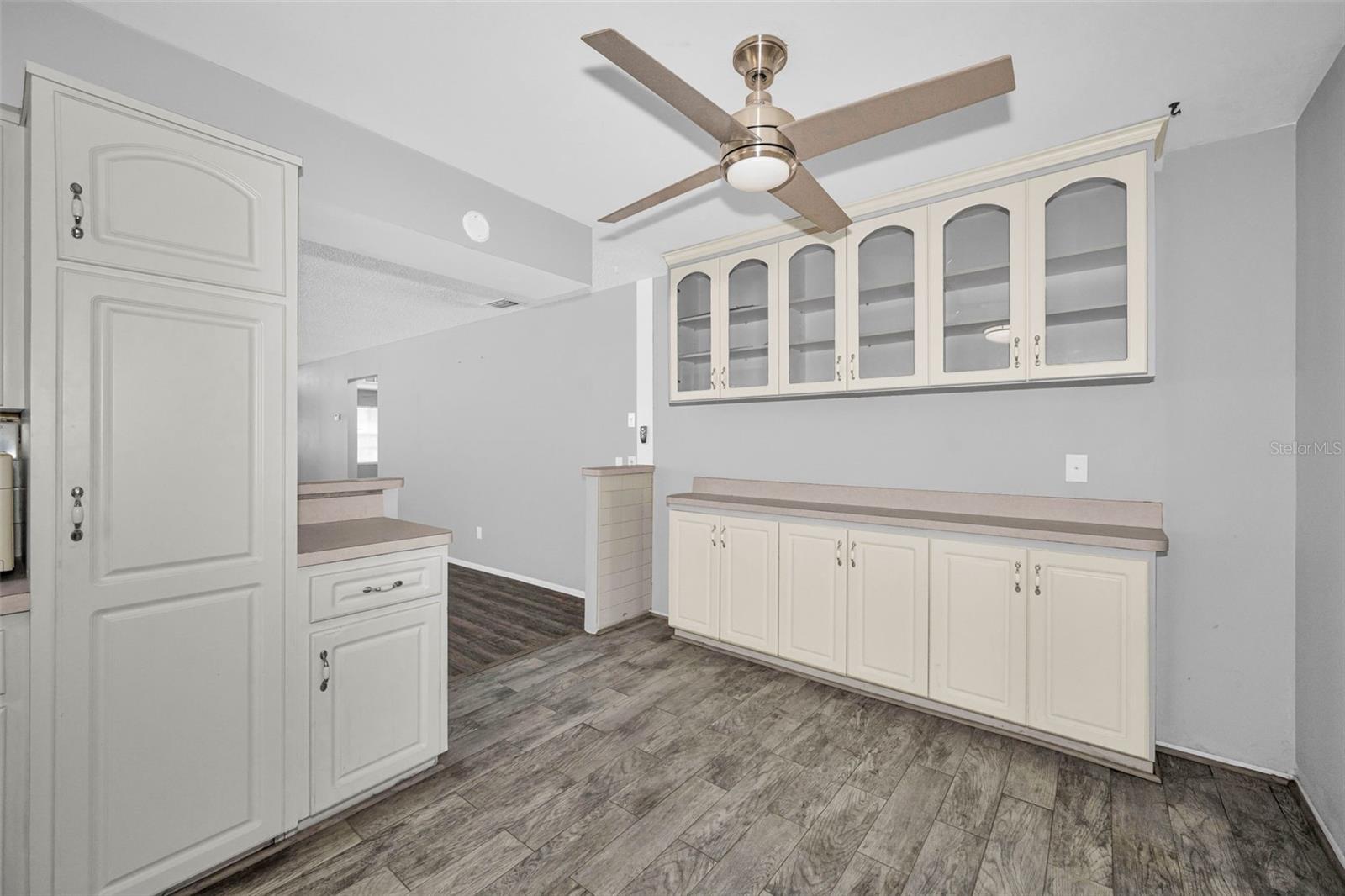 Beautiful built in cabinets in Kitchen with fan and laminate floors.