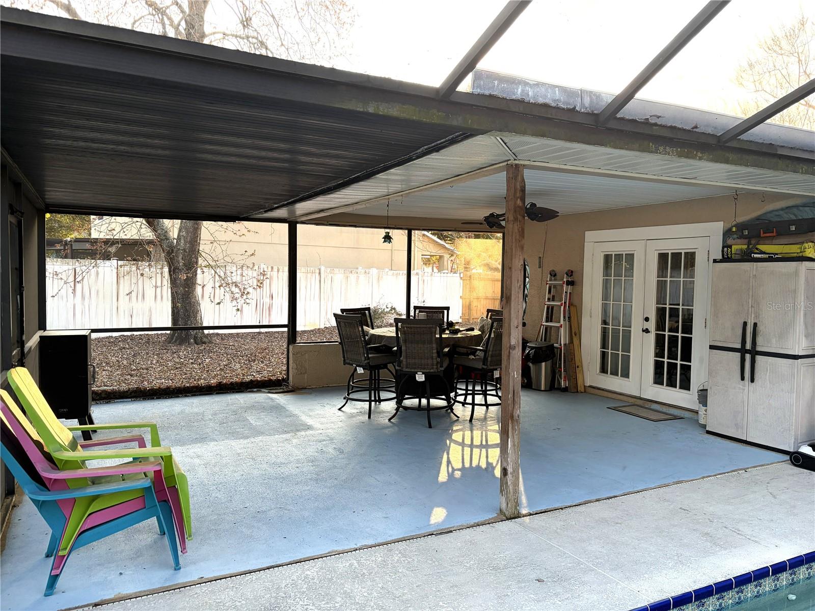 Covered screen enclosure overlooking pool