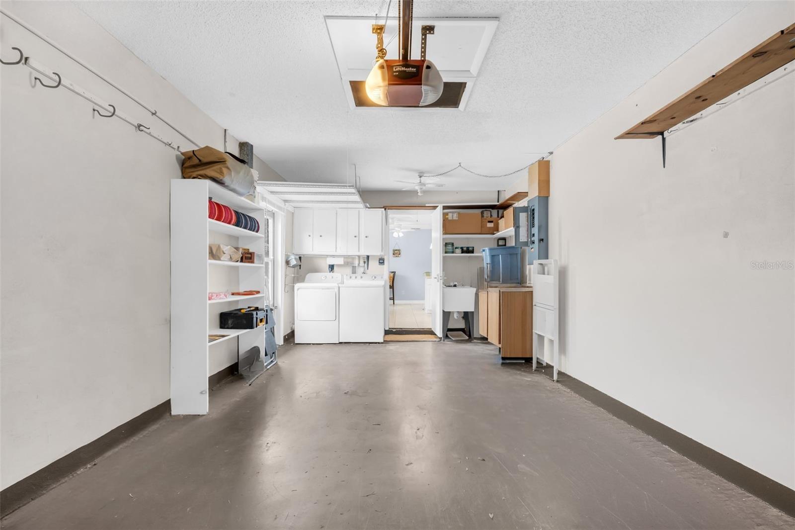 Oversized attached 1-car garage with private laundry station and utility sink~