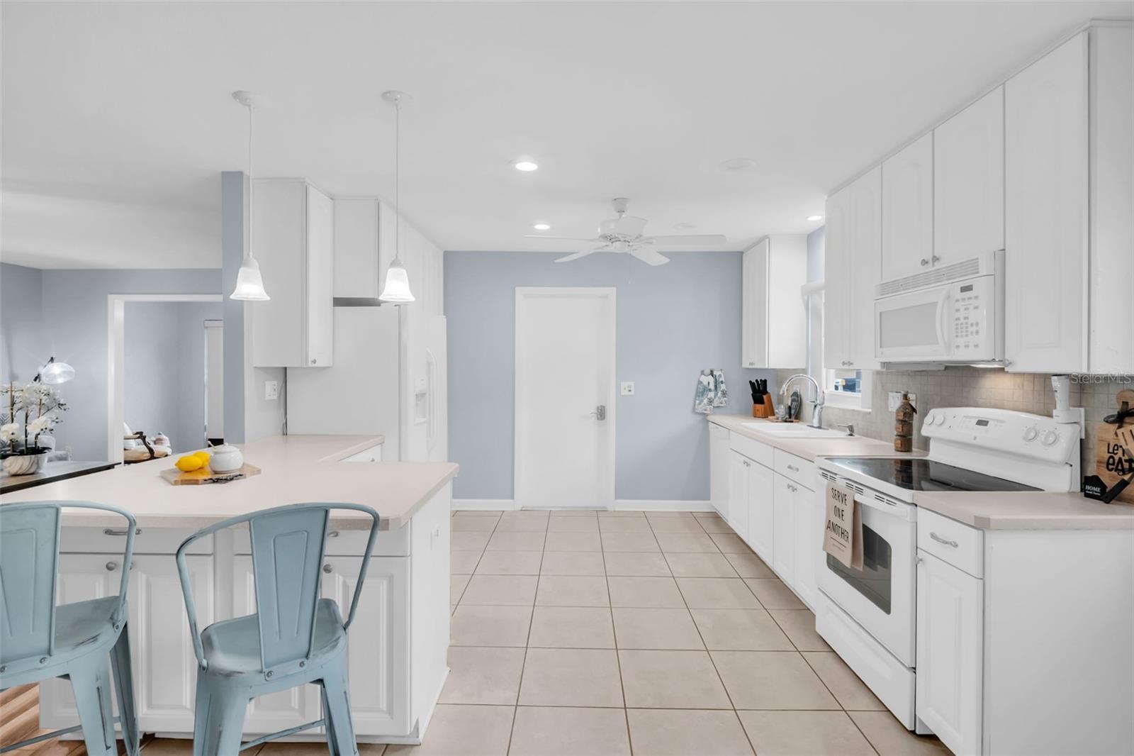 Bar seating, newer appliances, recessed lighting, and convenient garage access~