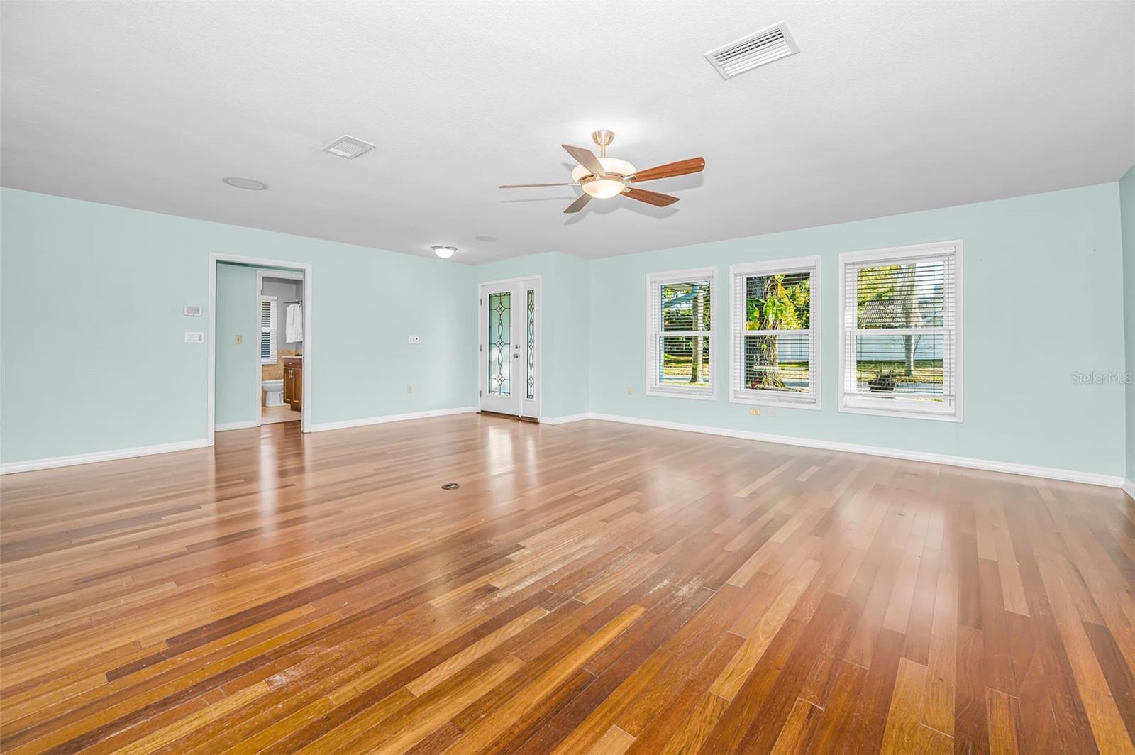 Living Room with beautiful flooring and hurricane window