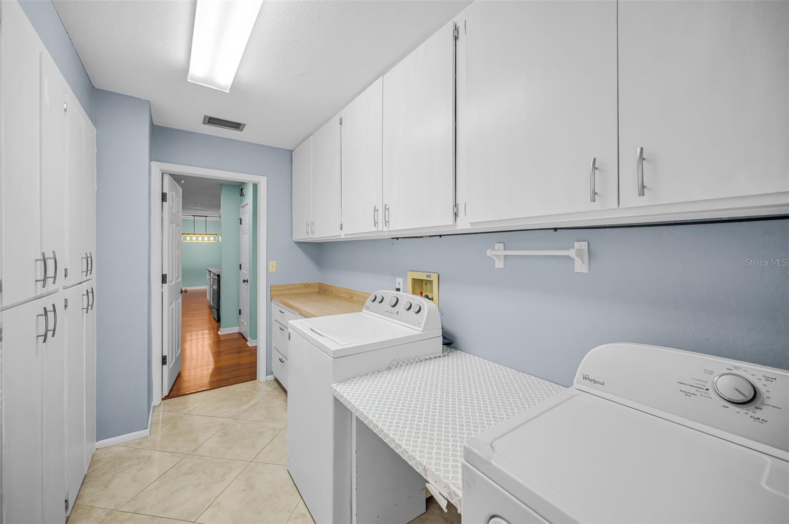 Huge inside laundry room with extensive storage.