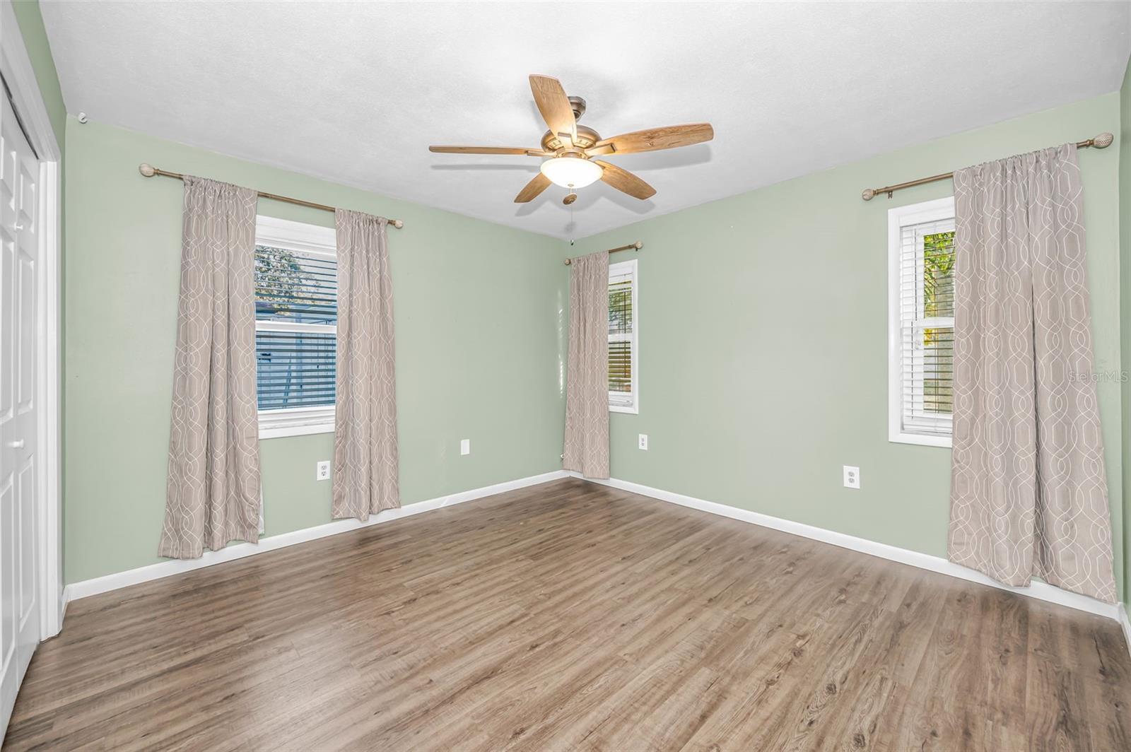 Bedroom 2 with hurricane windows and double door closet