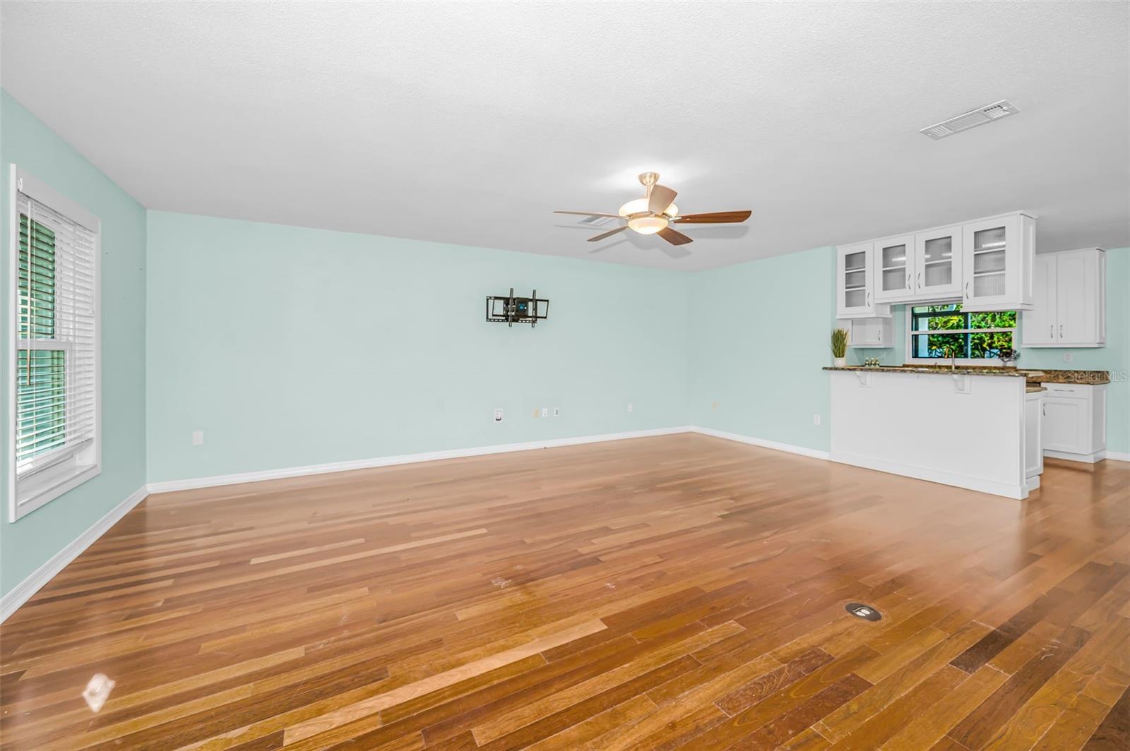 Living room is adjacent to kitchen and breakfast bar.