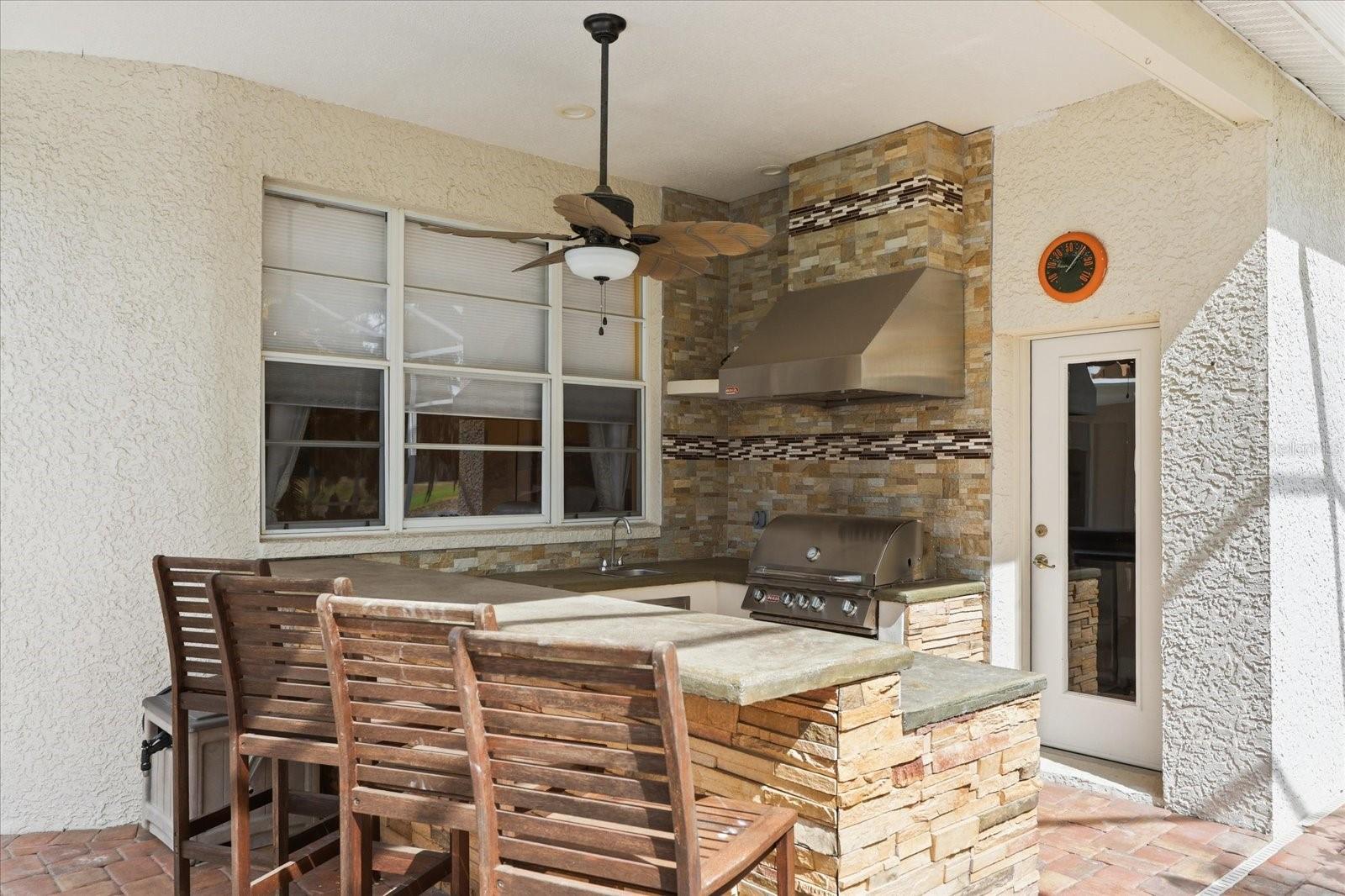 Outdoor Kitchen and Door to Pool Bath