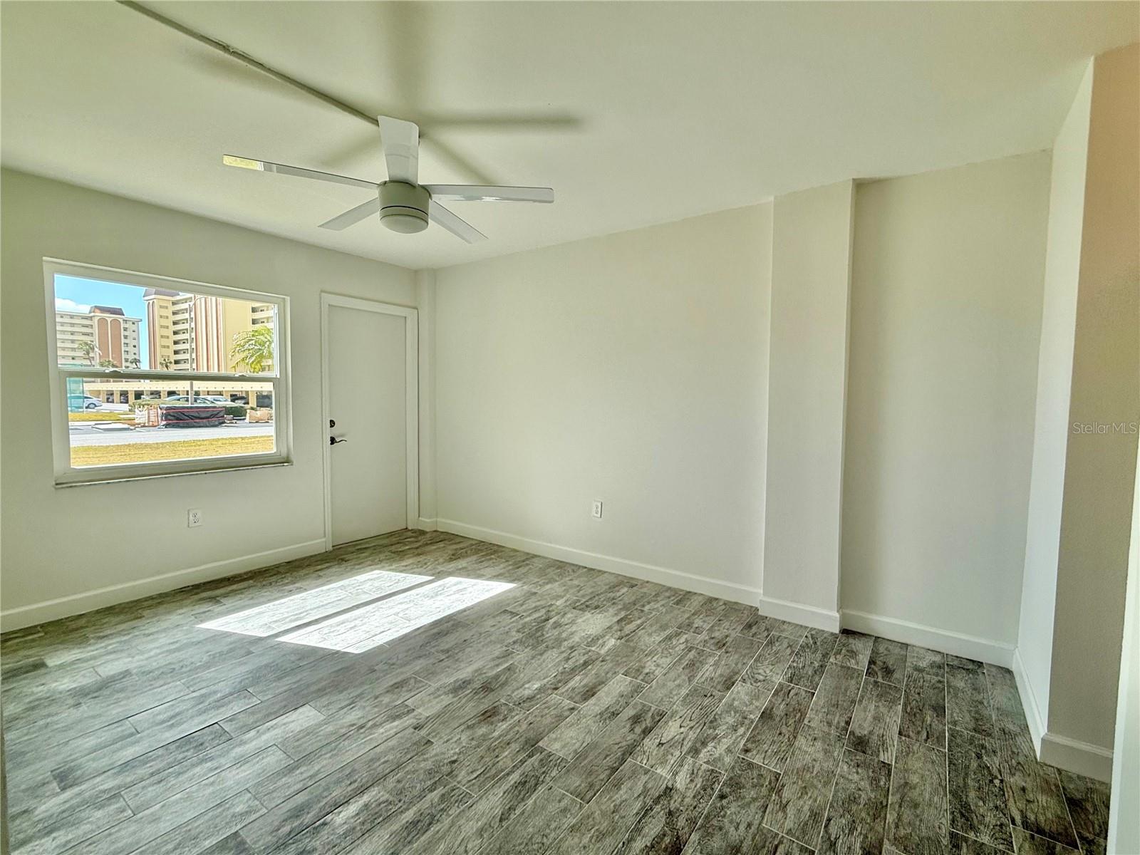 Large 14x11 bedroom with tile flooring.