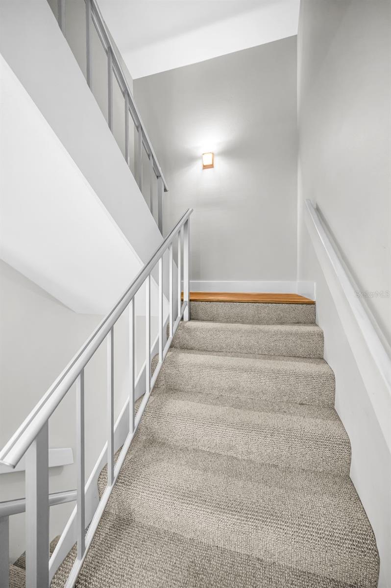 Metal railing and staircase leading to the Upper Level