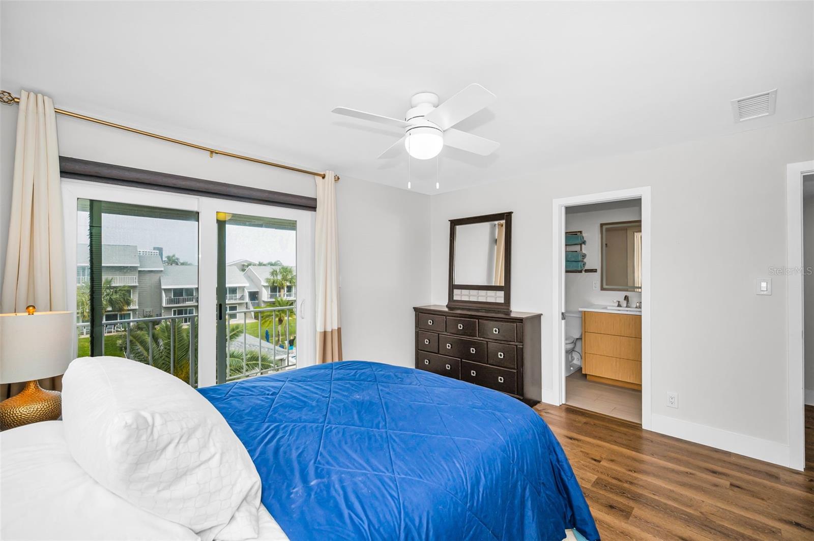 Upper Level (3rd floor) Primary BR with sliding glass door to the private balcony