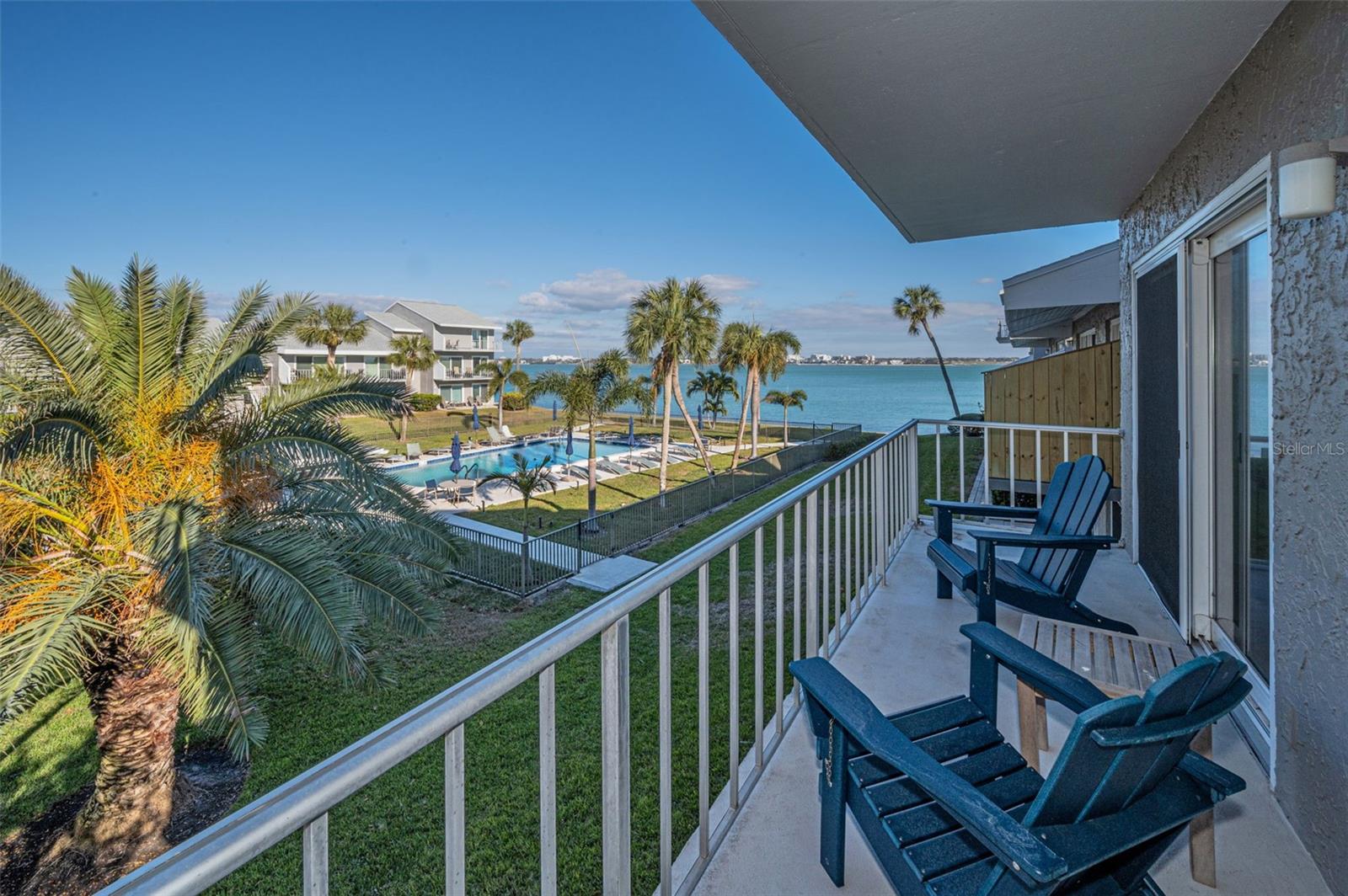 A breezy balcony with beautiful, wide-open waterfront views that capture the essence of coastal living