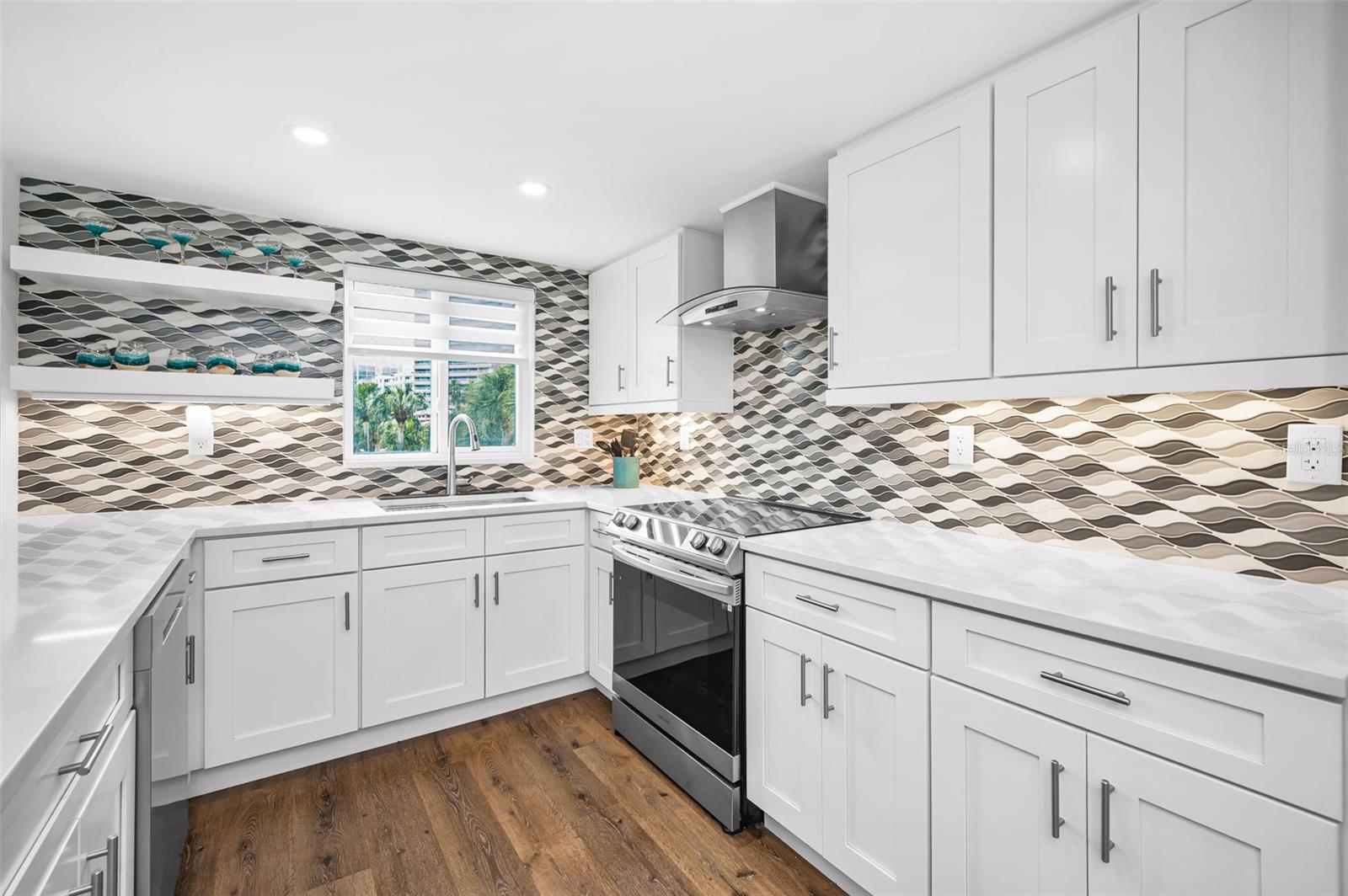 A bright, coastal-contemporary kitchen featuring streamlined cabinetry, sleek finishes, and an airy, beach-influenced aesthetic