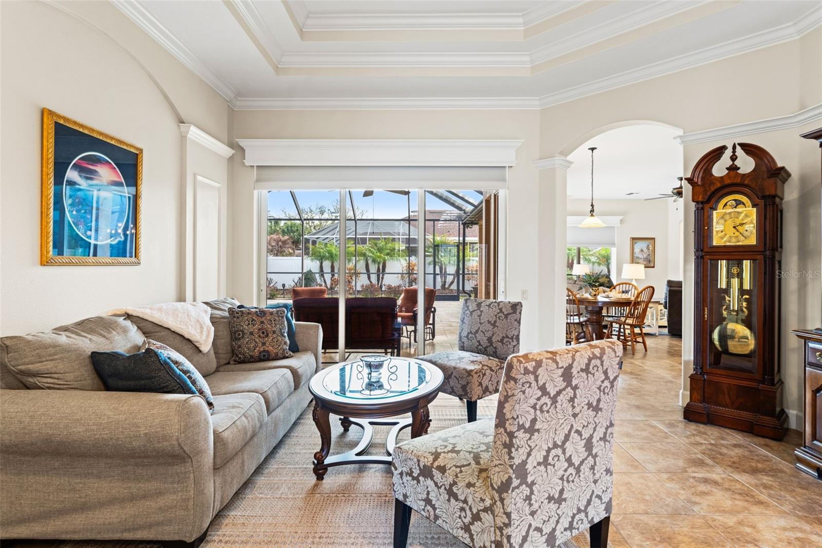 The open layout connects the living room to the dining area through graceful archways, enhancing flow for everyday living and entertaining.