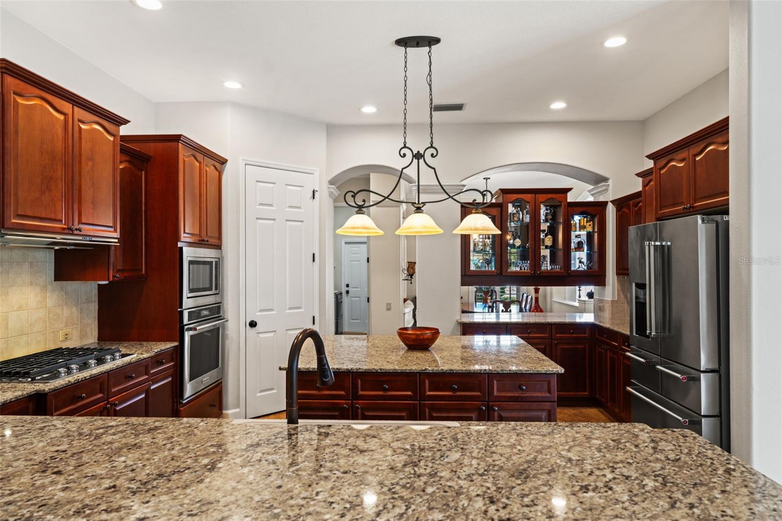 Designed for functionality and flow, the kitchen offers abundant storage, expansive counter space, and seamless access to the main living areas.