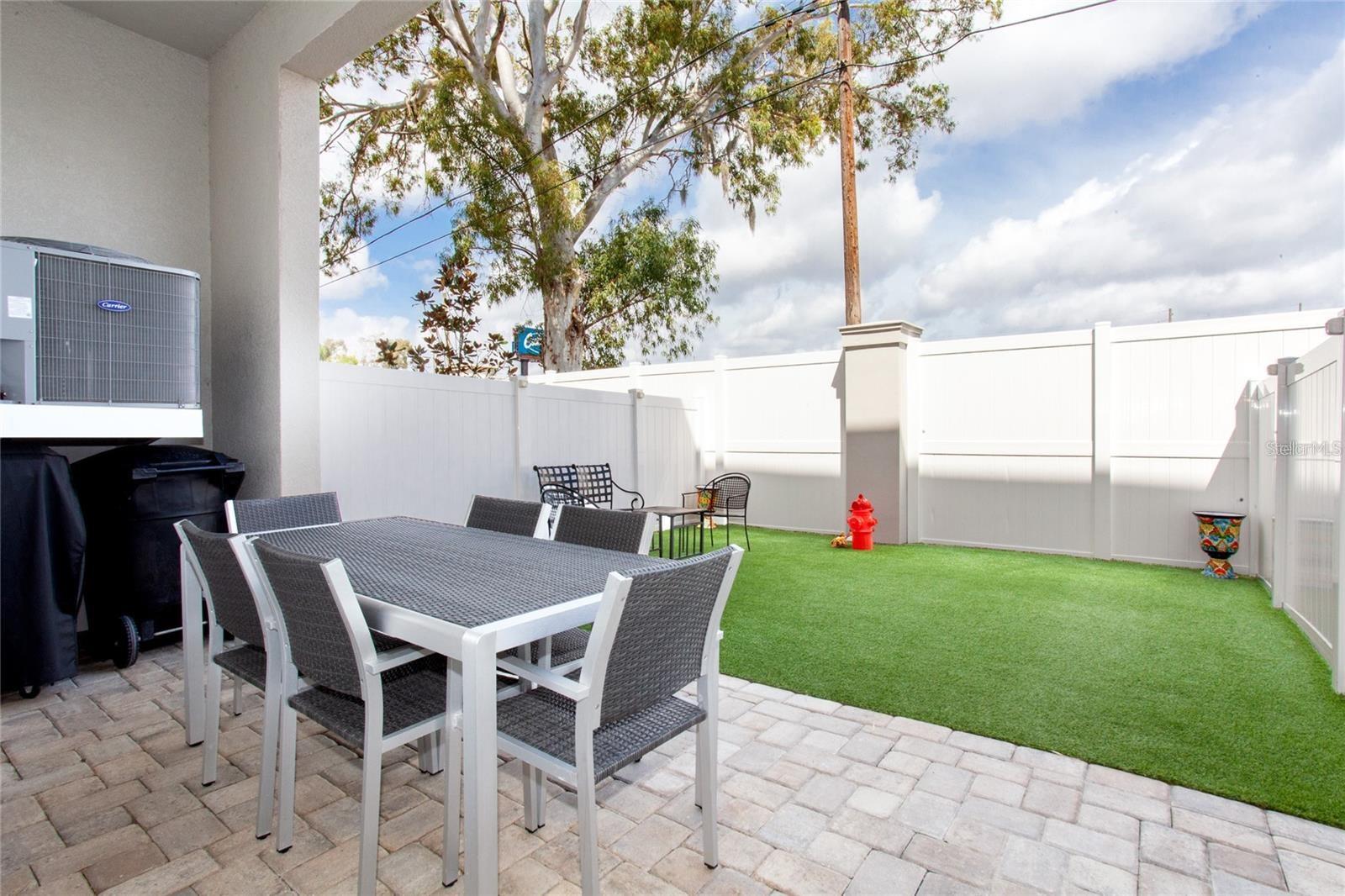 First Level exit from garage fenced in area with turf