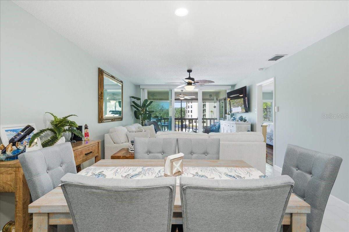Dining area just off kitchen with convenient counterspace for serving and views out the wall of sliding glass doors to the balcony.