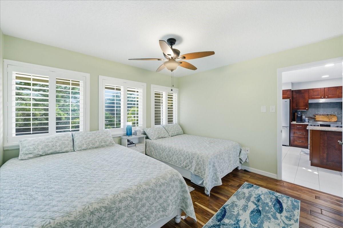 Second bedroom at the front of the unit with its own tastefully updated en-suite bathroom, three windows, beautiful wood-look tile flooring, decorative ceiling fan and California Closet.