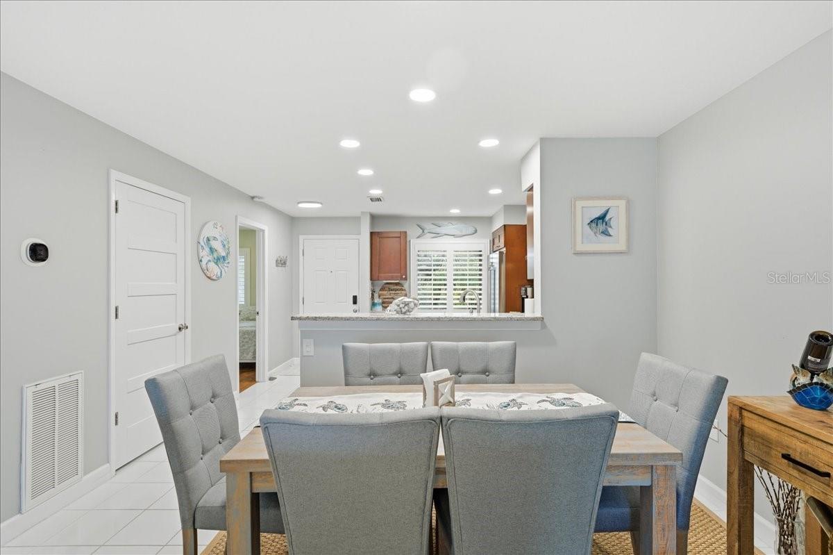 Dining area just off kitchen with convenient counterspace for serving and views out the wall of sliding glass doors to the balcony.