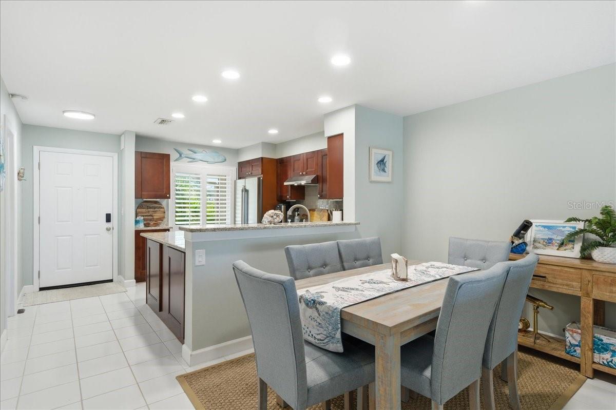 Dining area just off kitchen with convenient counterspace for serving and views out the wall of sliding glass doors to the balcony.