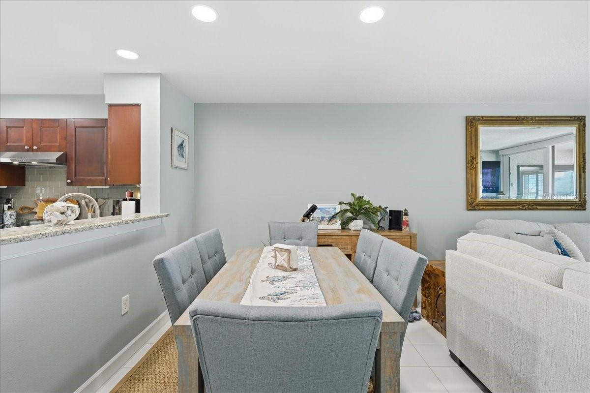 Dining area just off kitchen with convenient counterspace for serving and views out the wall of sliding glass doors to the balcony.