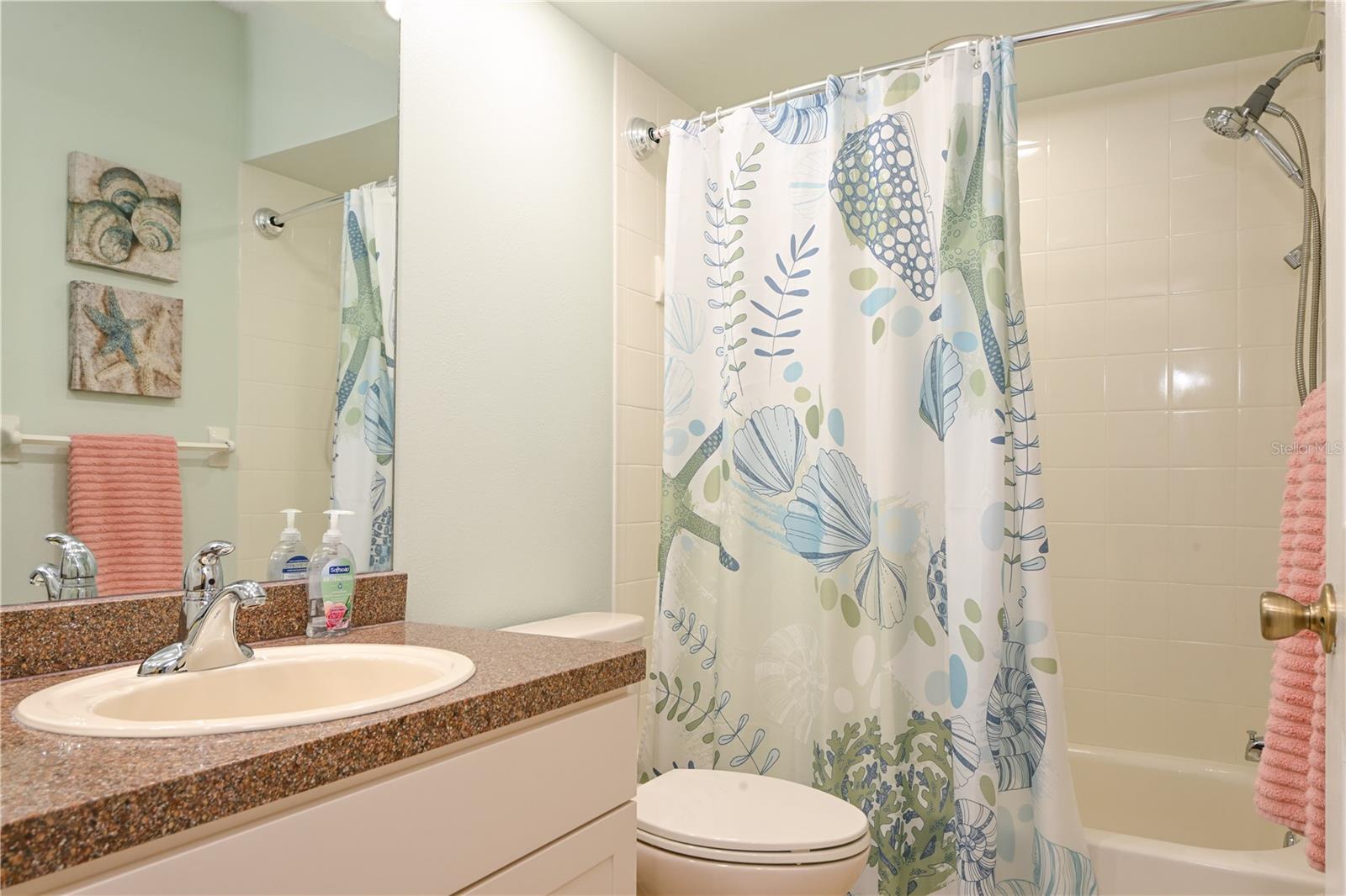 Sparkling reglazed guest bathtub and tile.