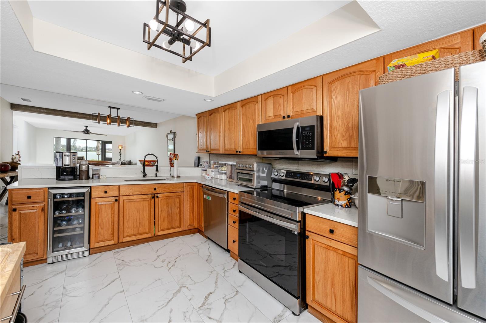 Kitchen with farmhouse sink, stainless appliances and wine refrigerator
