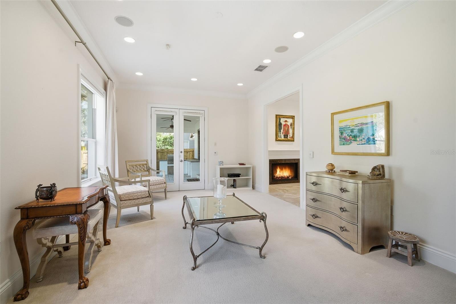 Livingroom looking to kitchen and French Doors leading to the covered Lania.