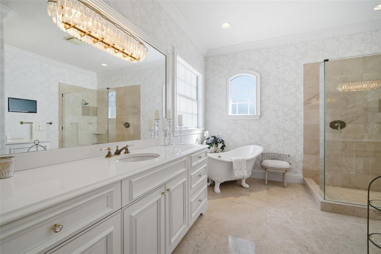 Primary Bath with clawfoot style tub, Separate frameless walk-in shower, private WC and double vanities.