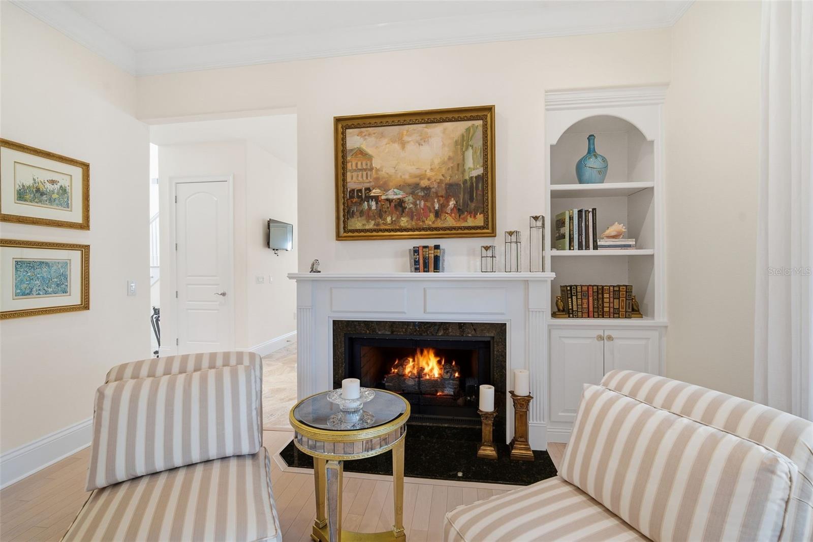 Family room looking to foyer and kitchen. seven overhead ceiling speakers and equipment to power them.