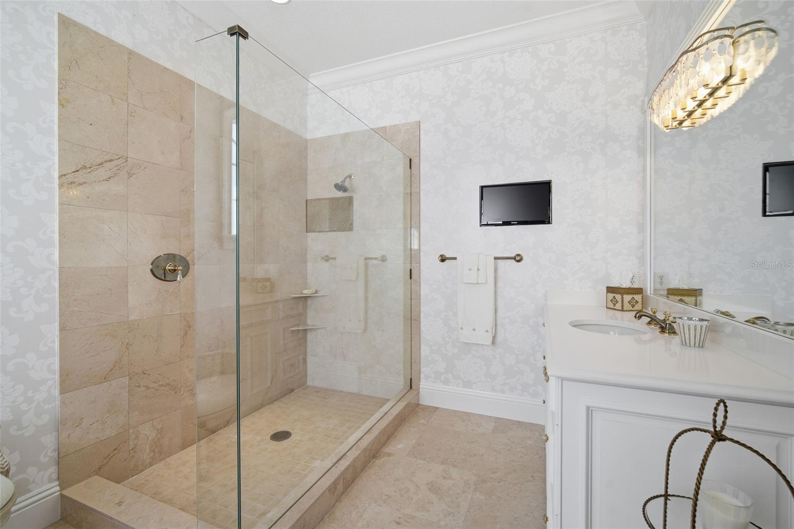 Primary bath shower and double separate vanities.
