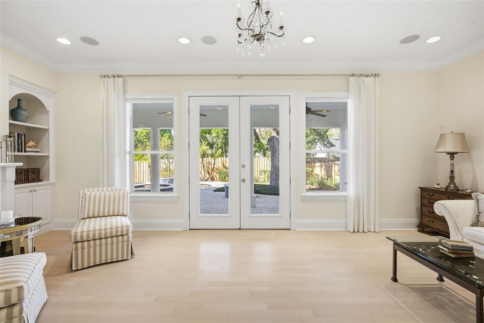 Family room looking through French Doors to large 27 X 23 Lania with built-in gas grill.
