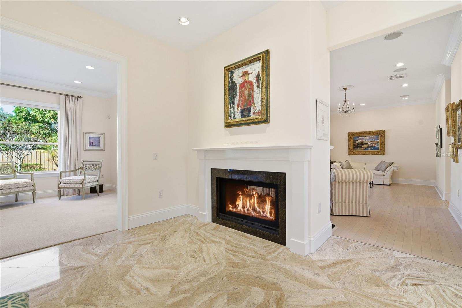 Kitchen double sided fireplace and looking to family room.