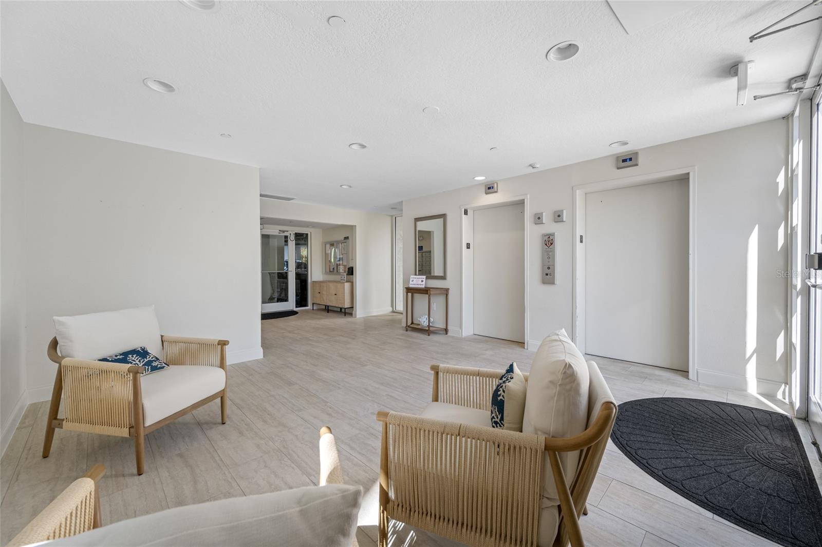 Dominica Lobby with two newer elevators, mail boxes, garage access.