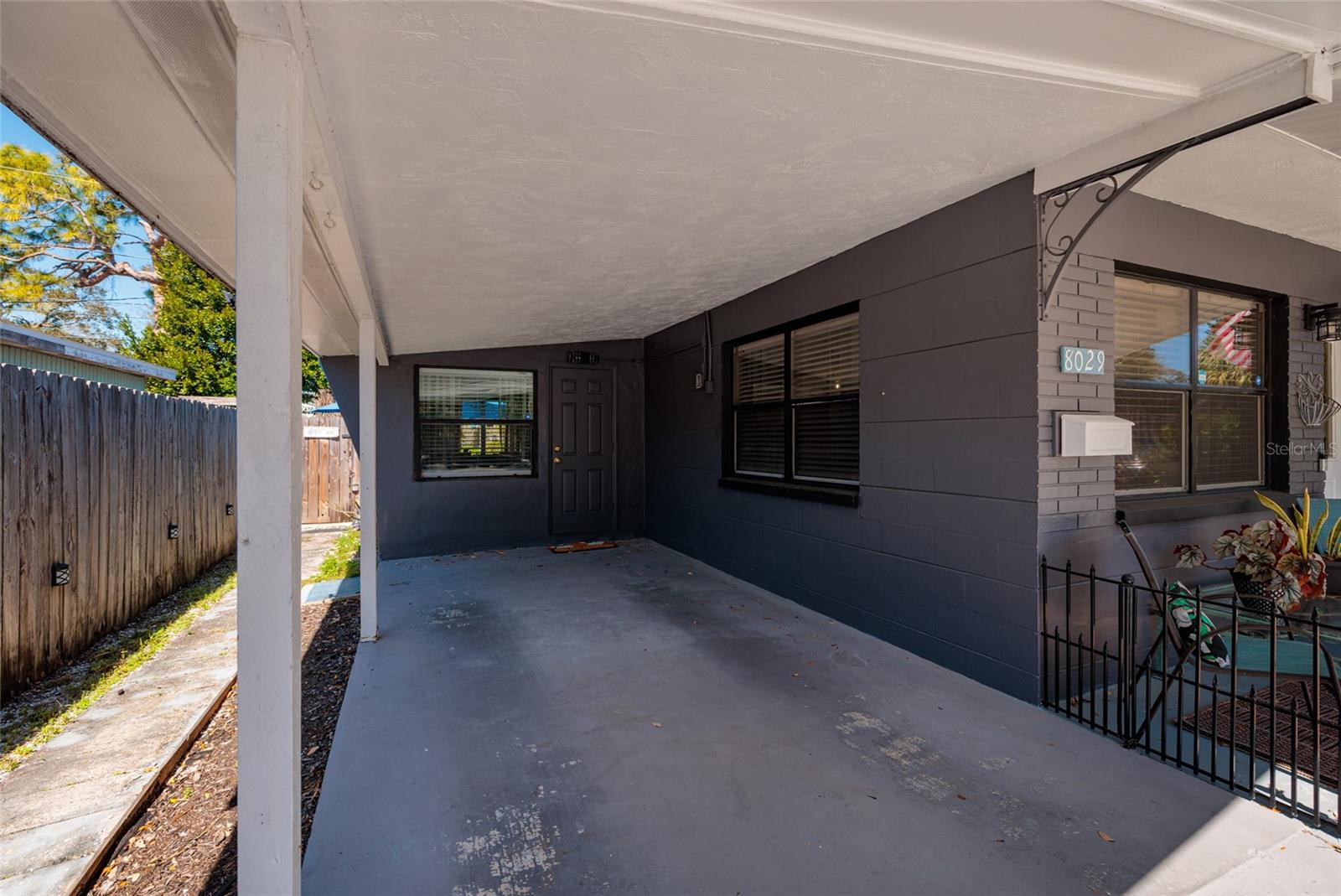 Large carport & sidewalk to back yard.