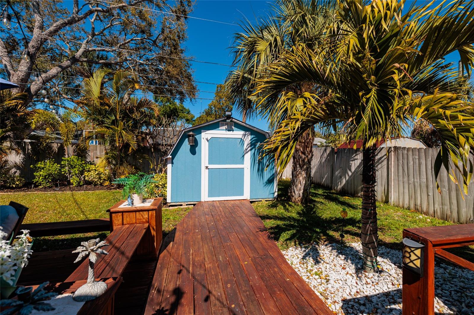 Deck walkway to large shed.