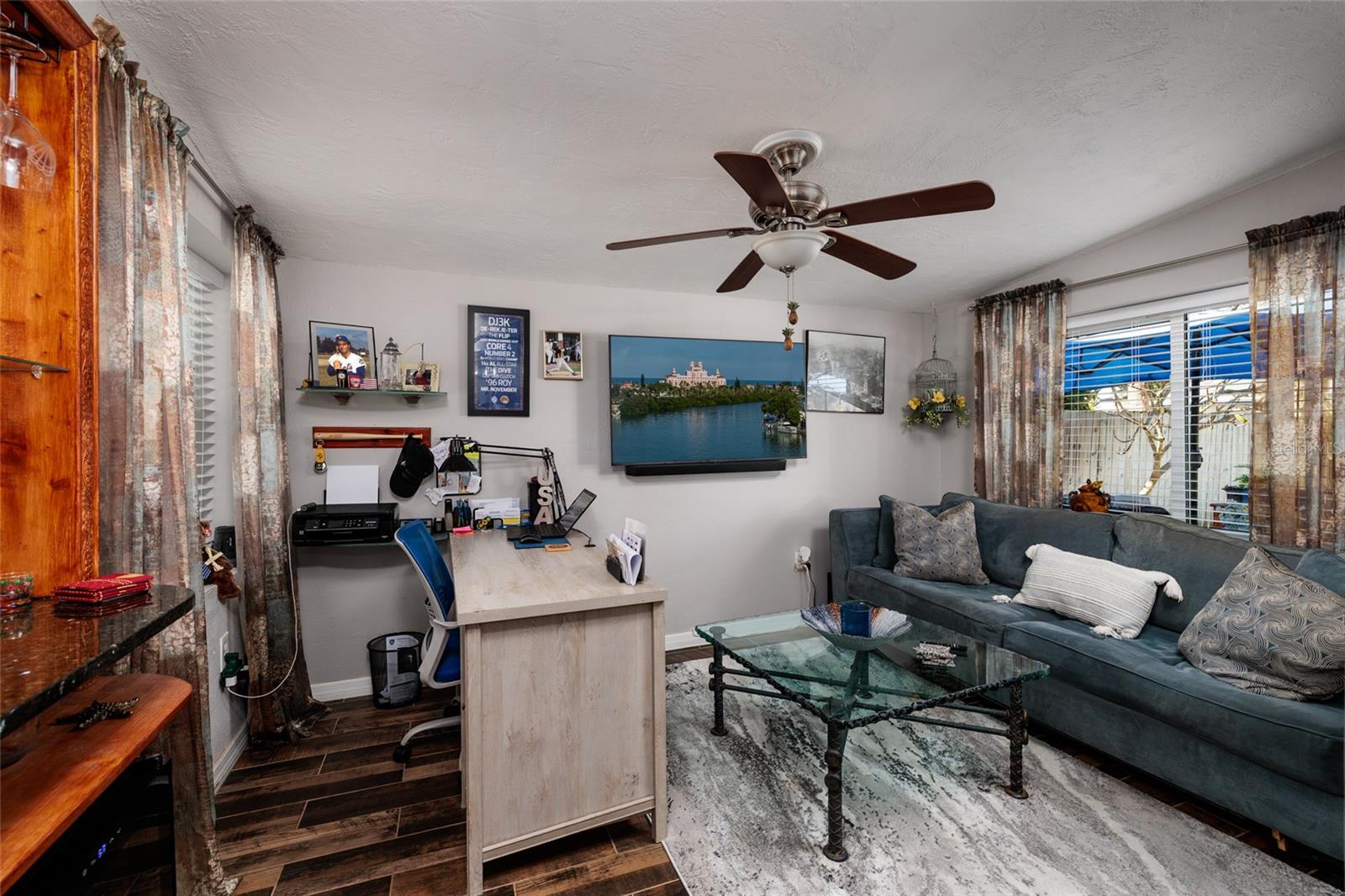 Office /Den w/Desk, Sleeper sofa & tile flooring. Also a built-in bar.