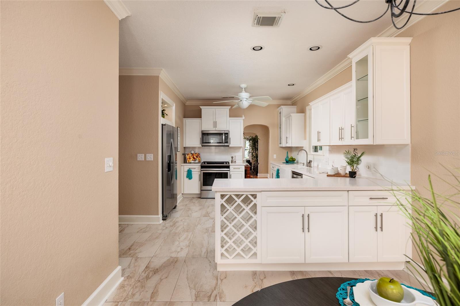 Breakfast room to Kitchen. Lots of built in storage and wine rack.
