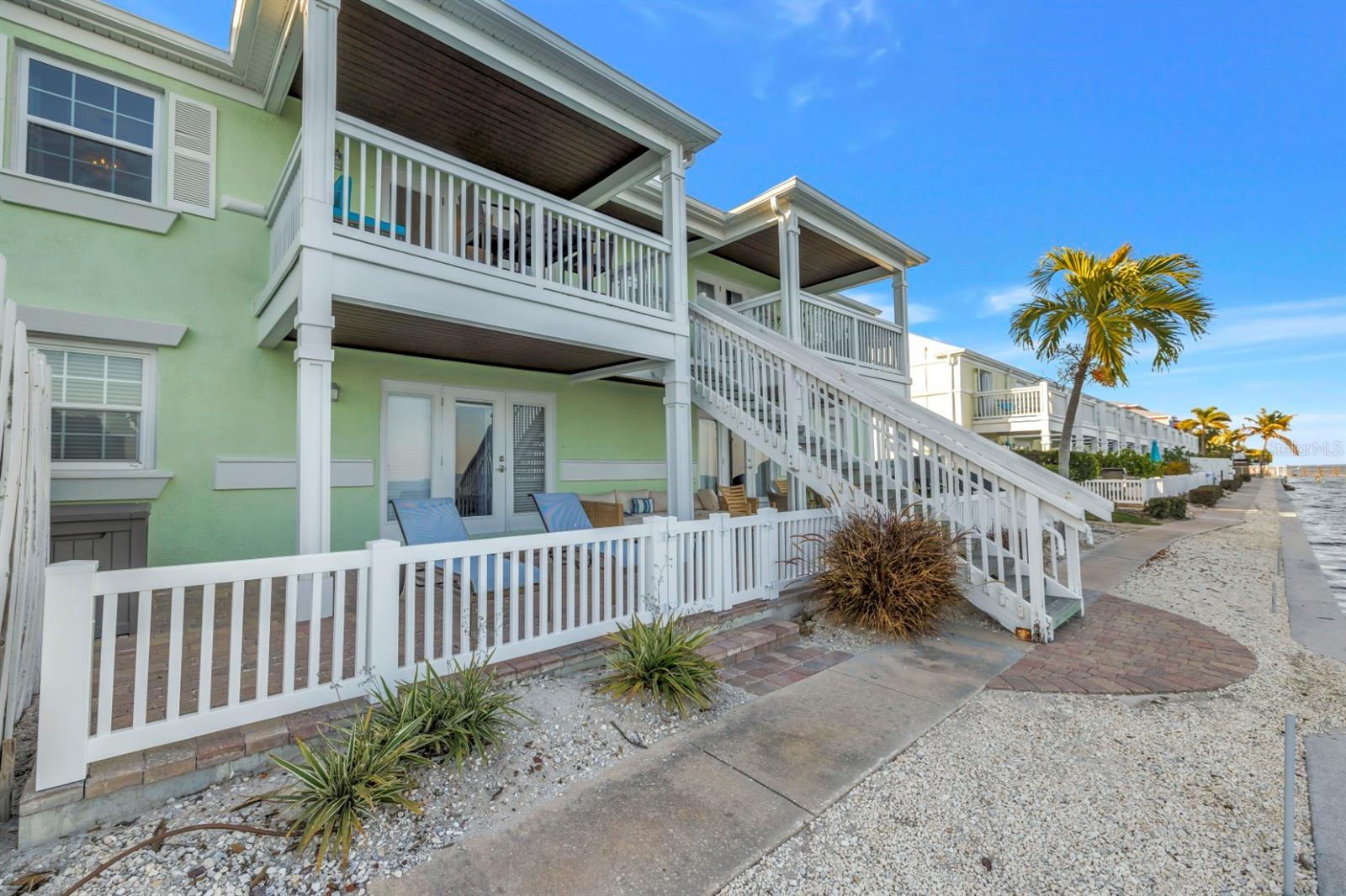 Convenient balcony access leading directly to picturesque waterfront pathways.