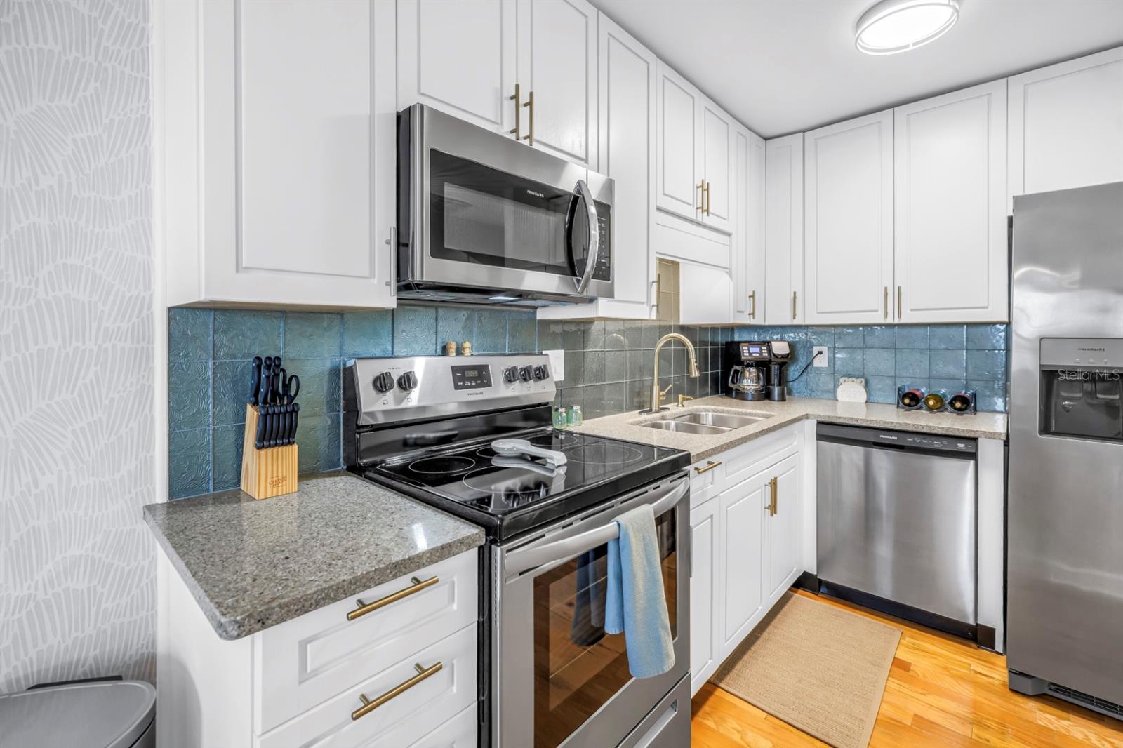 Beautifully updated kitchen featuring granite countertops and stainless steel appliances.