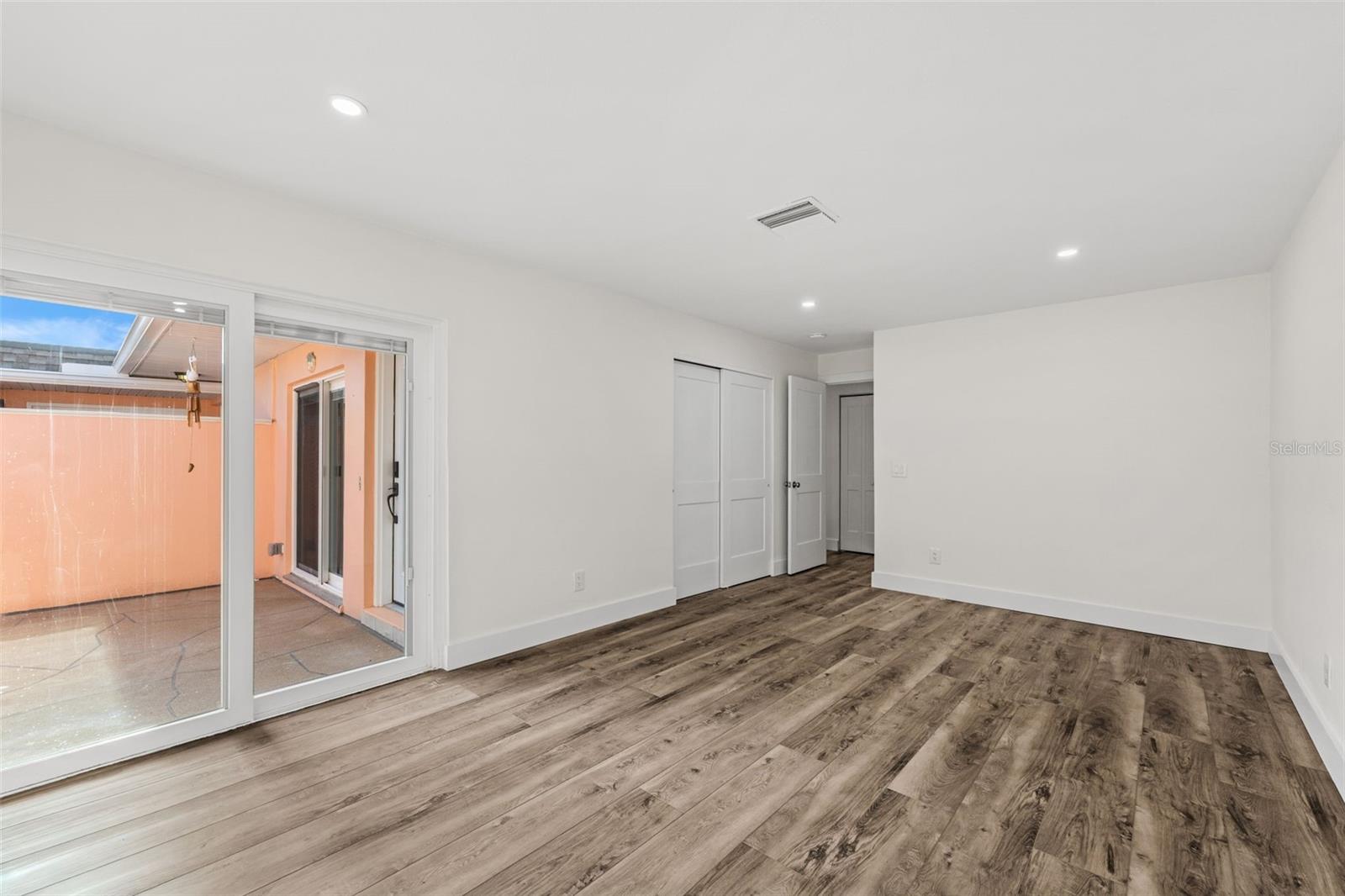 guest bedroom with slider to courtyard/ garage