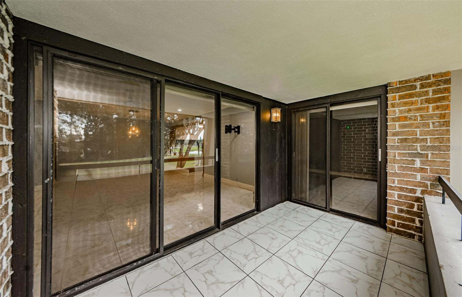 SLIDING DOORS TO LIVING ROOM OFF OF PRIVATE BALCONY