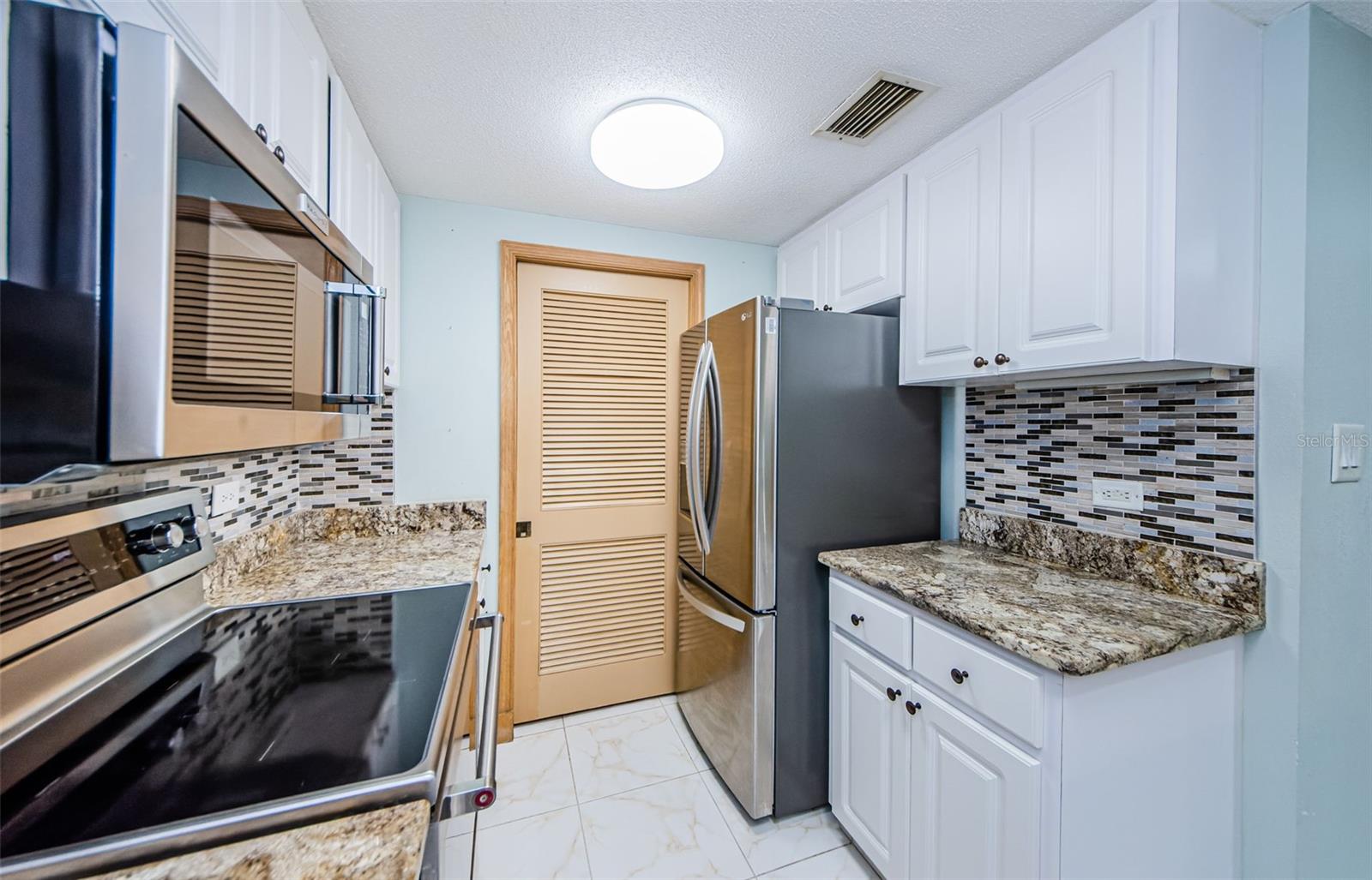 PANTRY LOCATED BEHIND SLIDING DOOR